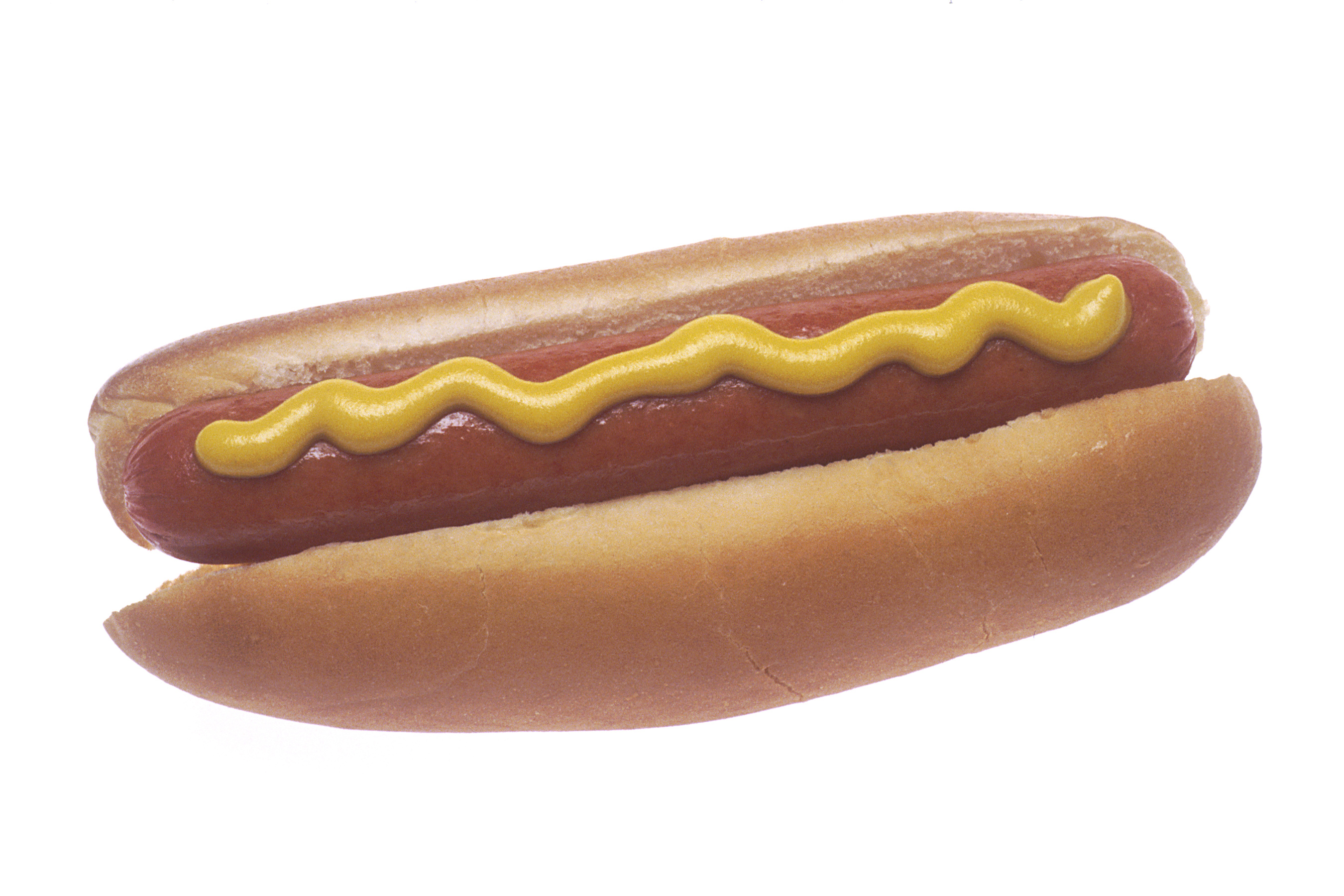A hot dog in a bun with mustard